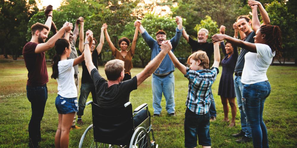 Group of people holding hand together in the park